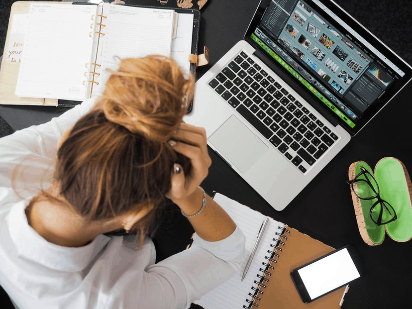 A woman stressed out and dealing with a headache.