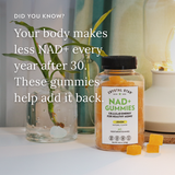 Crystal Star NAD+ Gummies bottle with text about NAD+ levels and gummies' benefits on a table.